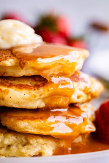 buttermilk syrup recipe drizzled over pancakes with butter.