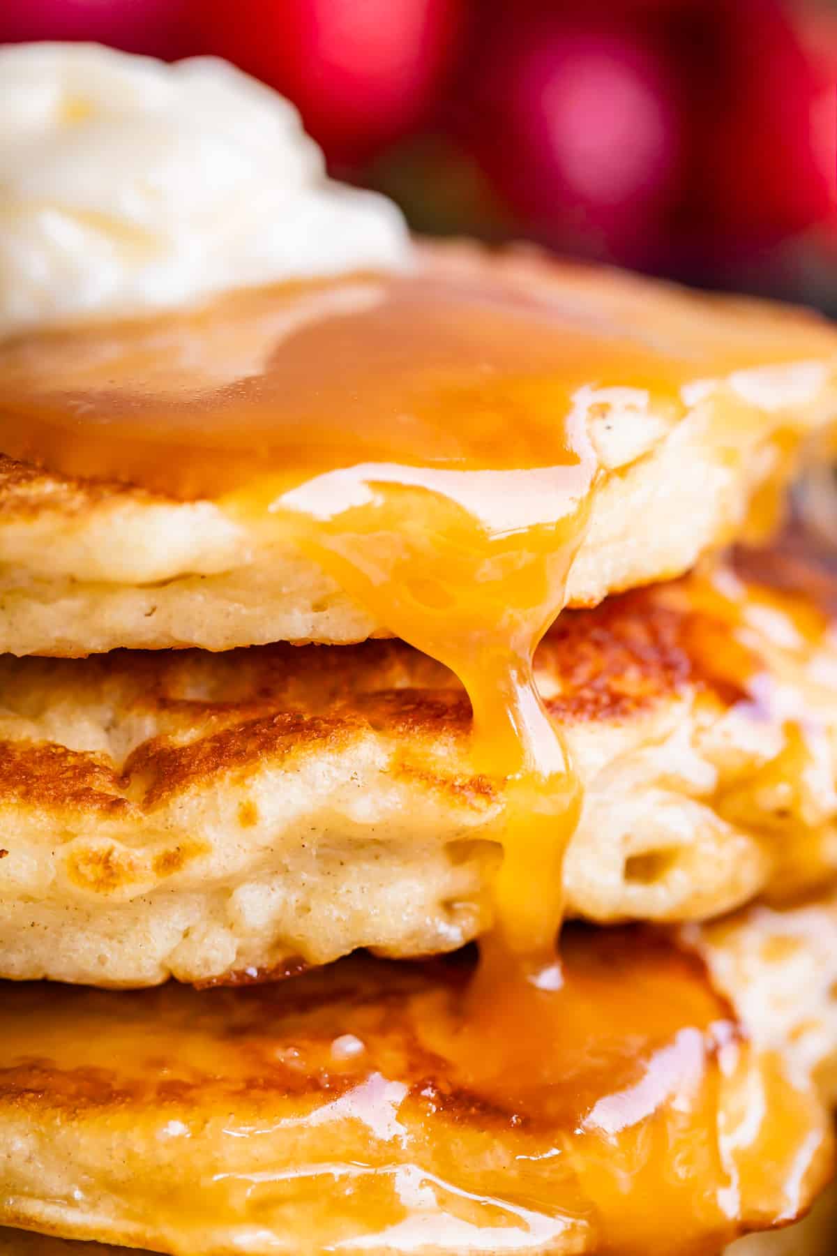 homemade buttermilk syrup drizzled over pancakes with butter.