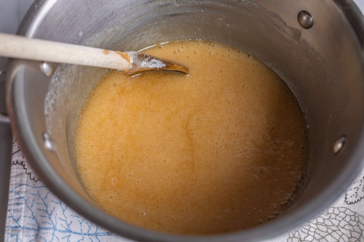 buttermilk syrup in a pot with a wooden spoon.