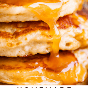 close up shot of buttermilk syrup recipe being drizzled over stack of pancakes.
