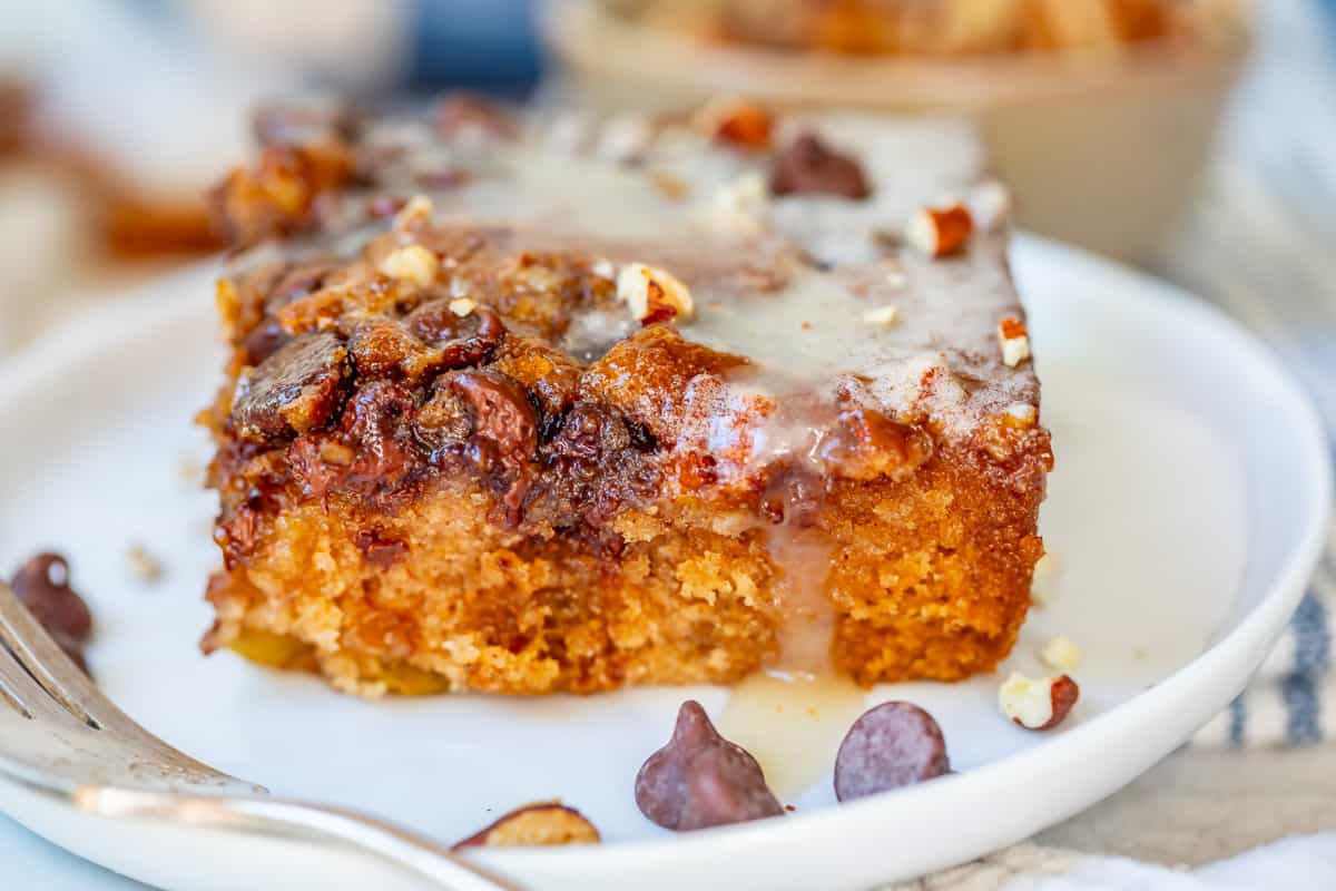 horizontal view showing layers of a cut piece of picnic cake on a plate with a fork.