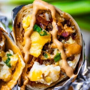 Breakfast burrito cross section with chipotle mayo on top.