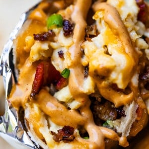 Close-up of breakfast burrito with chipotle mayo on top.