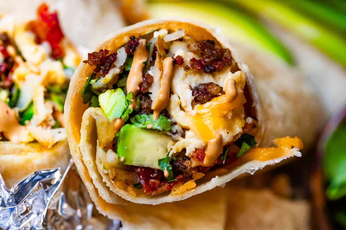 horizontal shot of breakfast burrito with chipotle mayo.