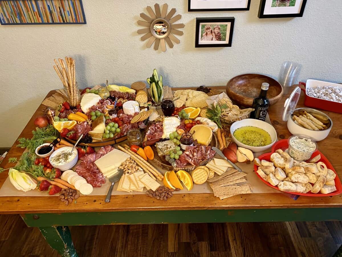 Charcuterie spread out on a wood table.
