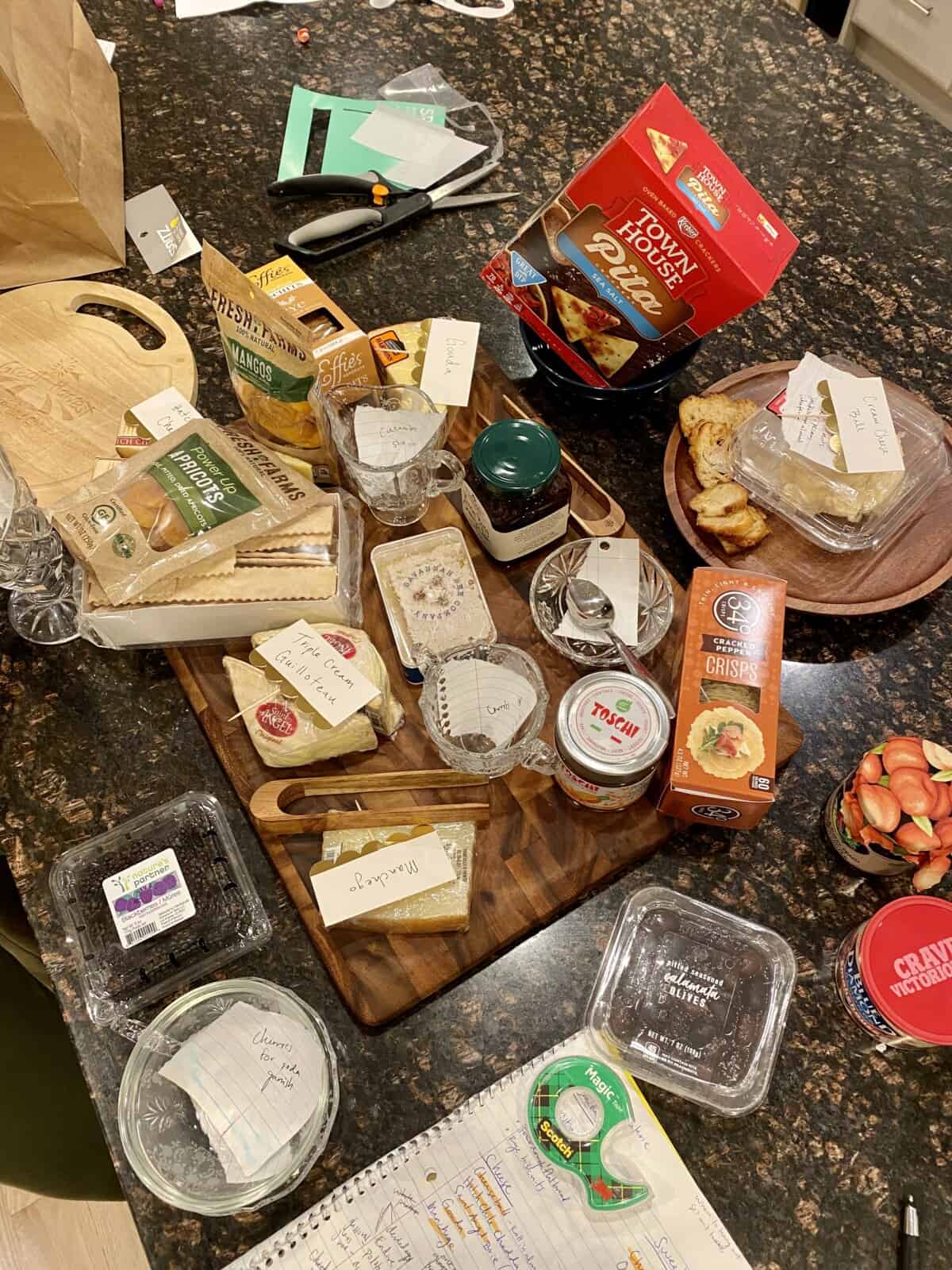 ingredients on a counter and board for making a charcuterie.