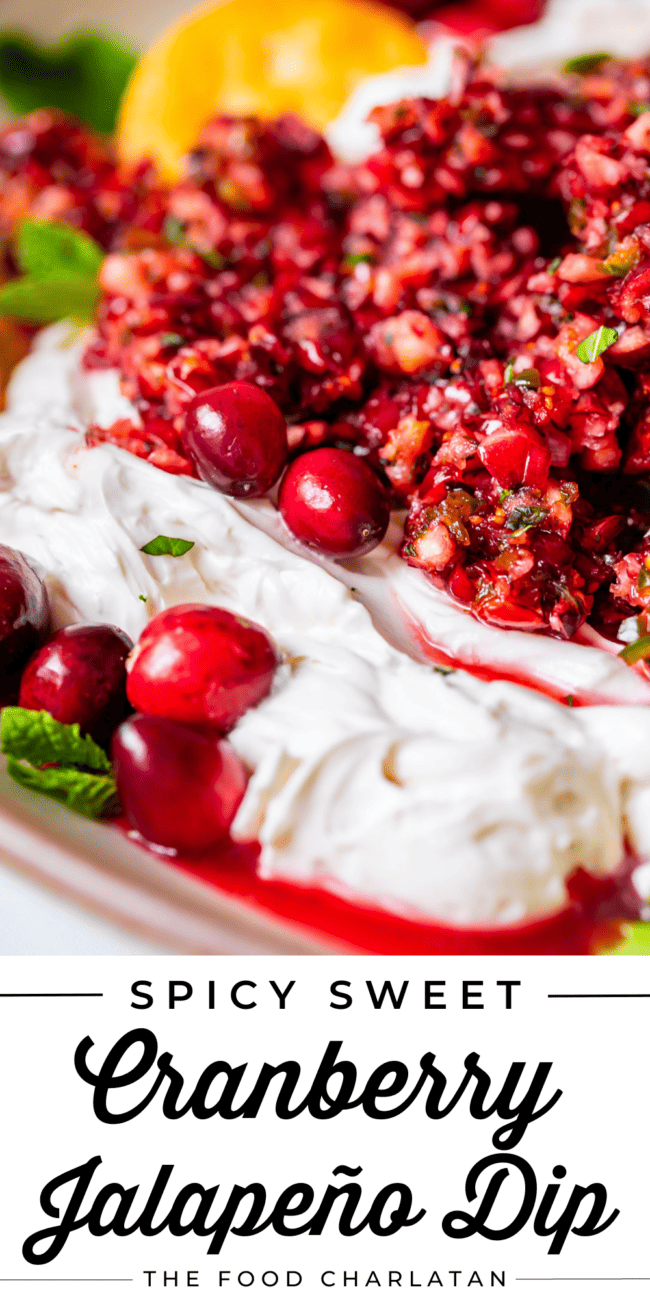 whipped cream cheese topped with cranberry jalapeno dip and fresh cranberries.
