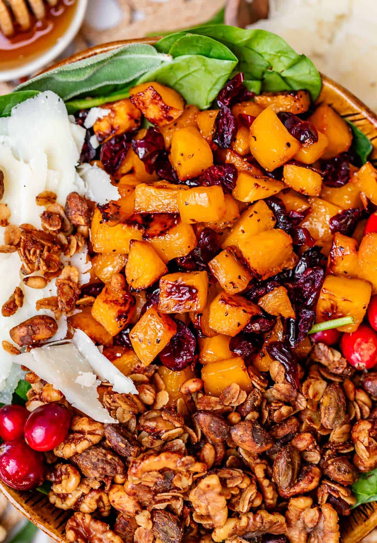 a bowl filled to the brim with honey roasted butternut squash salad.