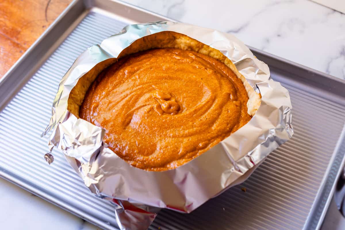 tin foil with a circle cut out of it around the crust/edges of the ready to bake pie.