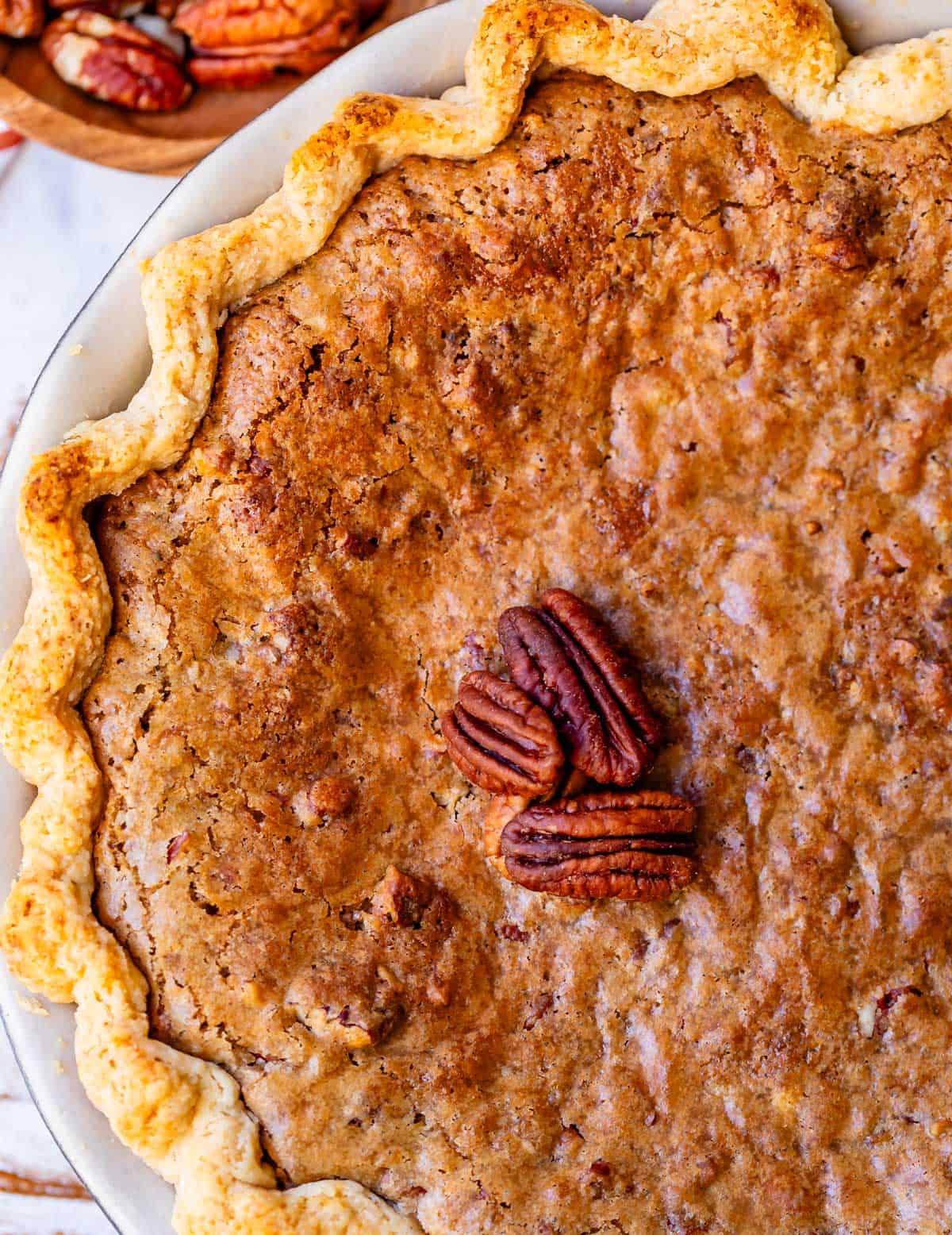 looking on top of a baked homemade sweet potato pie with praline topping.