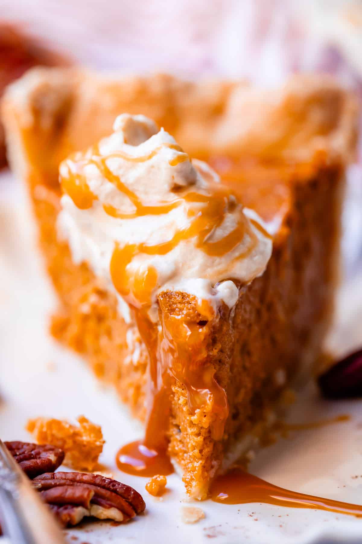 slice of pie with a dollop of whipped cream and extra caramel drizzled over the top.