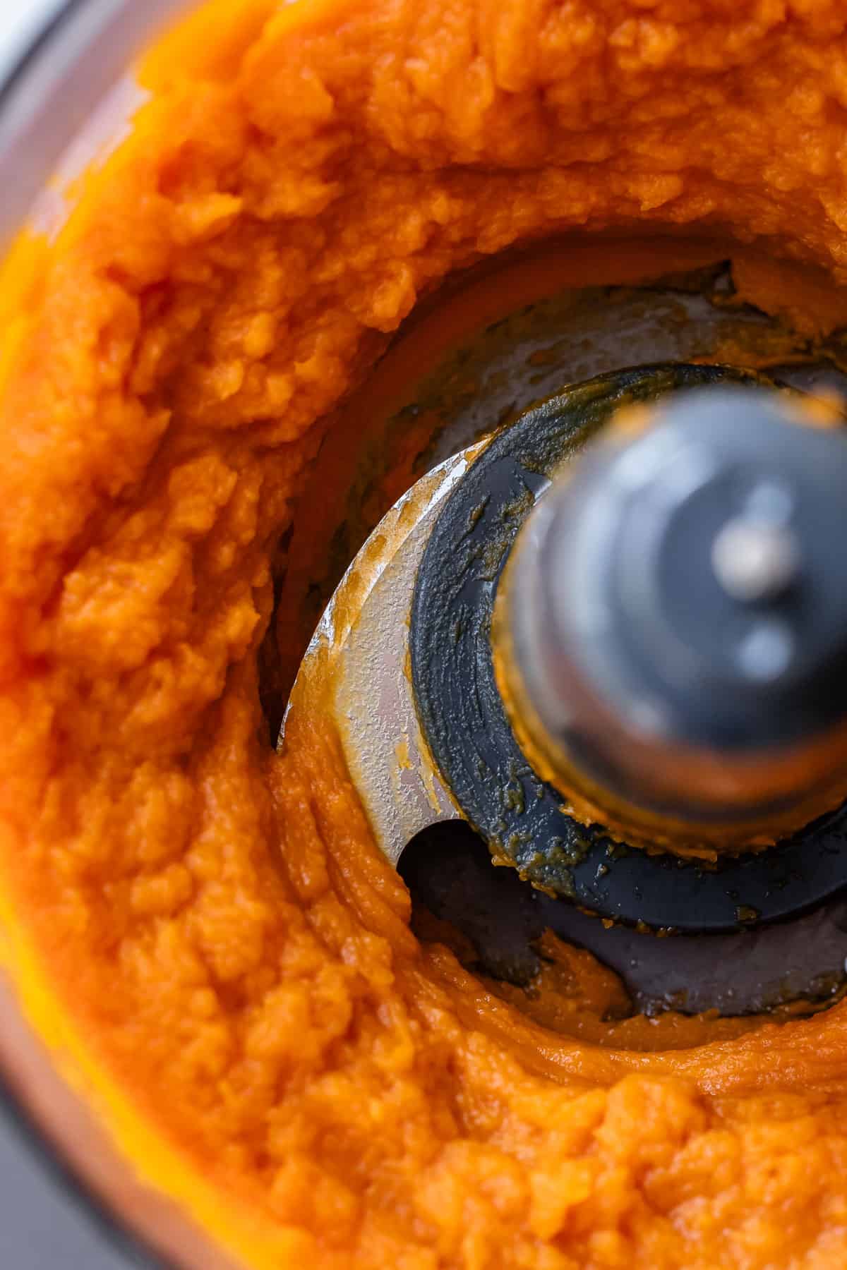 looking down into a food processor that has whipped roasted sweet potato smooth.