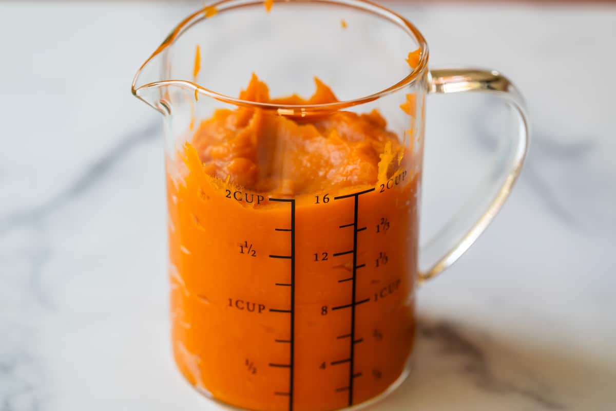 smooth, whipped sweet potato in a measuring cup, showing 2 cups measured.