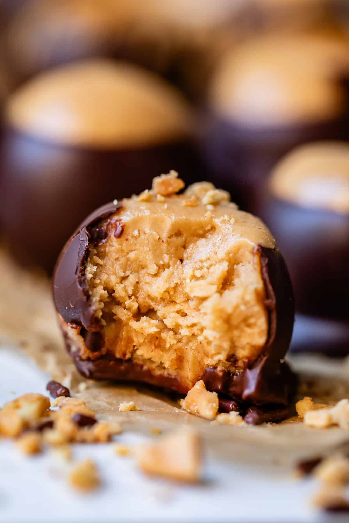 a peanut butter buckeye candy with a bite taken out.