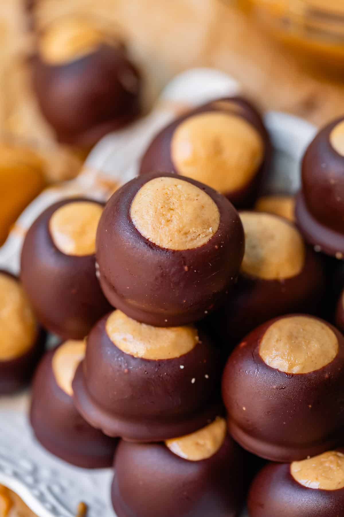buckeyes stacked on a white plate.