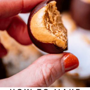 Buckeye with bite taken out of the candy held between thumb and forefinger.