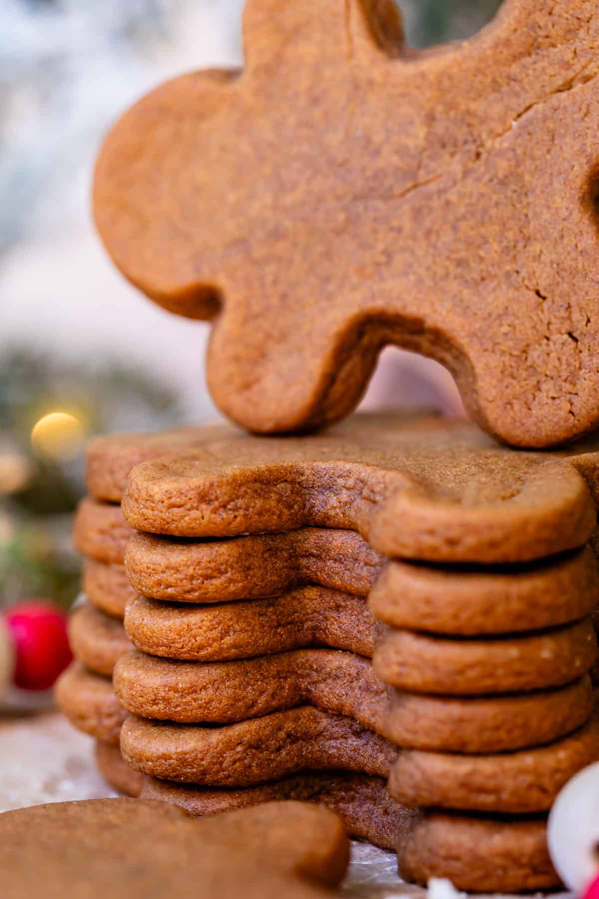 stack of baked gingerbread cookies with the top one being pulled from the pile.