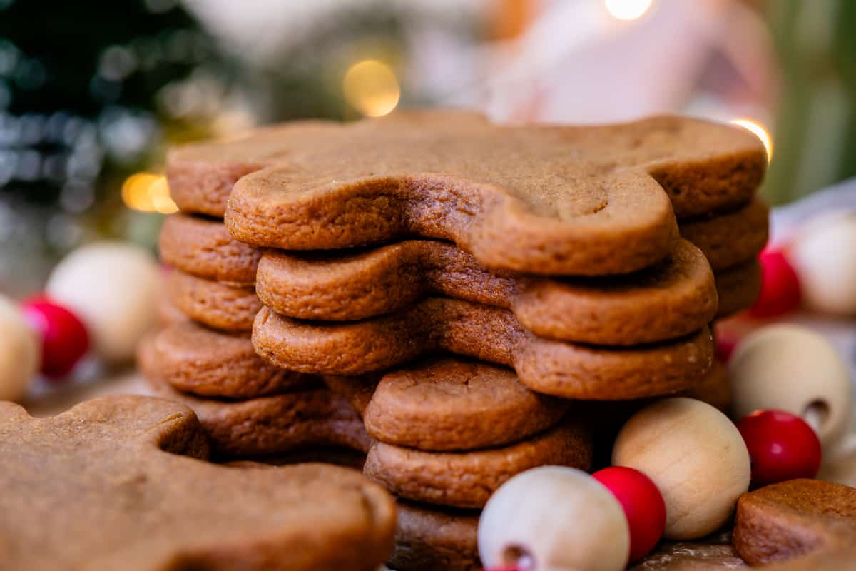 a side view of a stack of very think and well shaped, baked gingerbread man cookies.