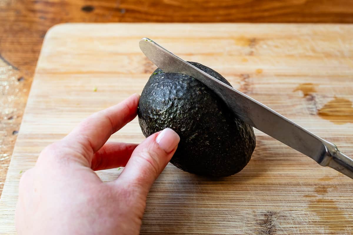 using a butter knife to more safely slice open an avocado (instead of a sharp knife).