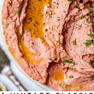 pate recipe in a bowl drizzled with oil and sprinkled with dill.