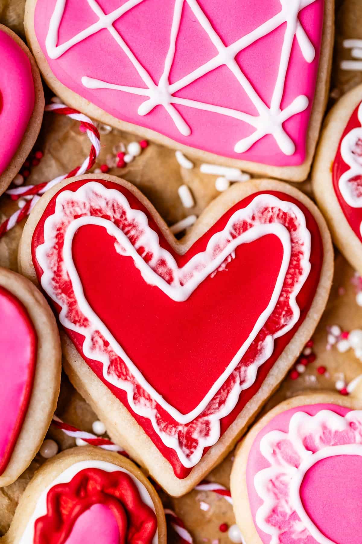 recipe for royal icing, shown on heart shaped sugar cookies.
