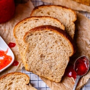 slices of rye bread on parchment paper on a cooling rack.