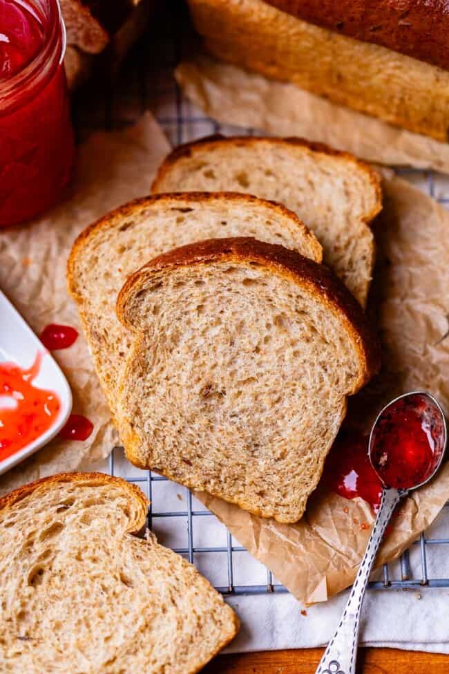 slices of rye bread on parchment paper on a cooling rack.