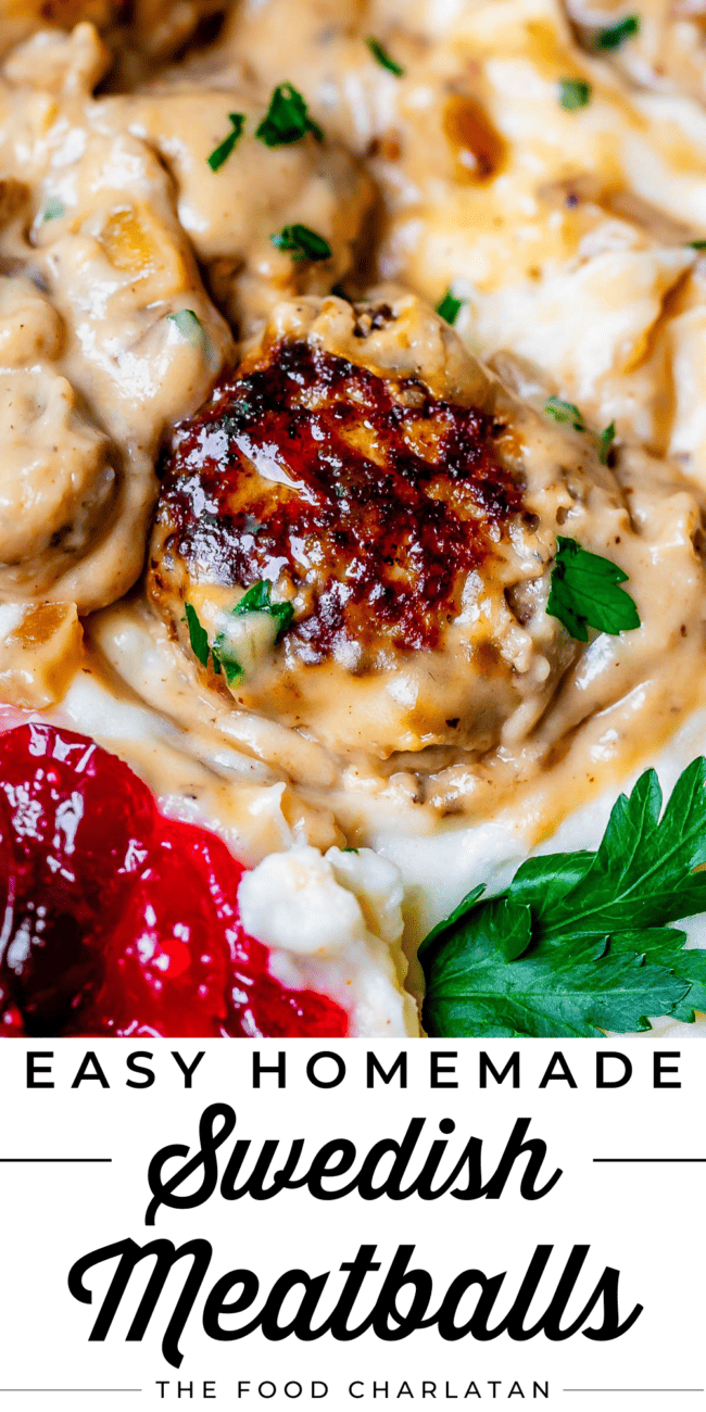 one meatball in gravy and mashed potatoes with cranberry sauce.