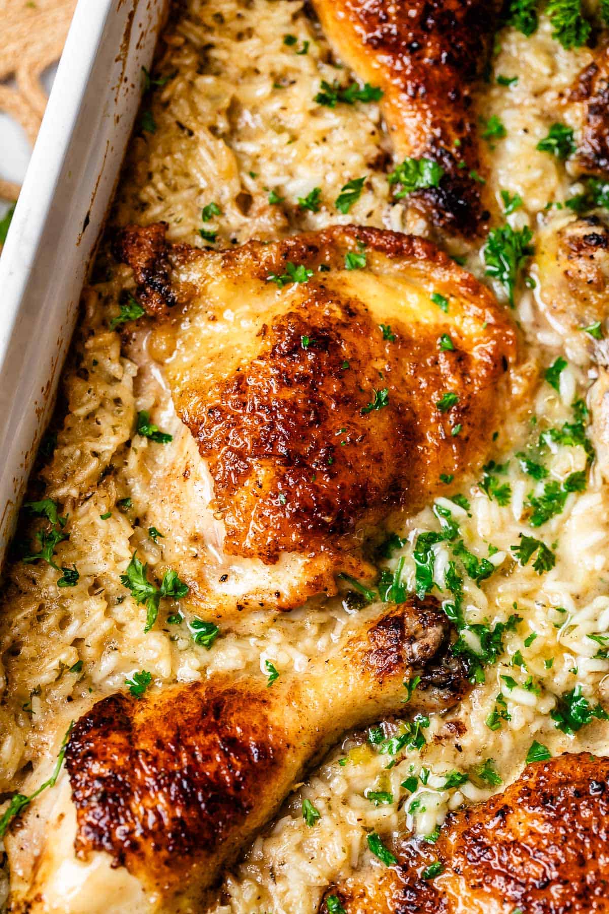cooked chicken pieces and creamy cooked rice in a casserole dish.