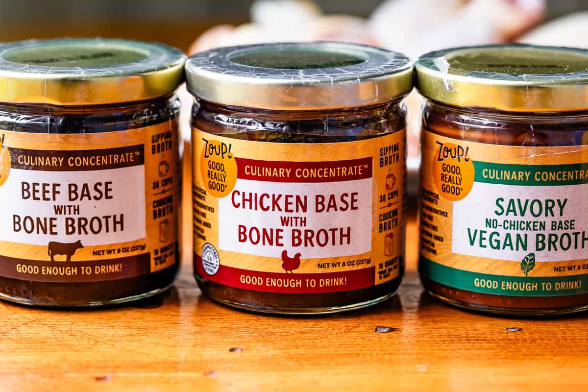 3 cans of broth base concentrate on a tabletop.