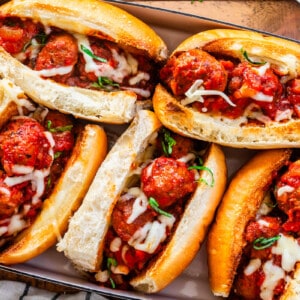 5 meatball subs in 9x13 pan ready to be broiled again for melty cheese over the top.