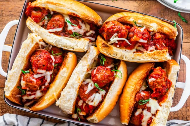 5 meatball subs in 9x13 pan ready to be broiled again for melty cheese over the top.