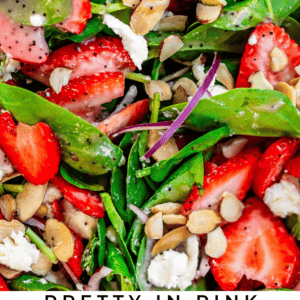 bright salad mix with text that says "pretty in pink strawberry spinach salad".