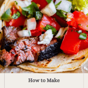 Close-up of a carne asada taco with grilled steak, diced tomatoes, onions, cilantro, guacamole, and crumbled cheese on a corn tortilla. Text overlay: How to Make Carne Asada, Get the Recipe, The Food Charlatan.