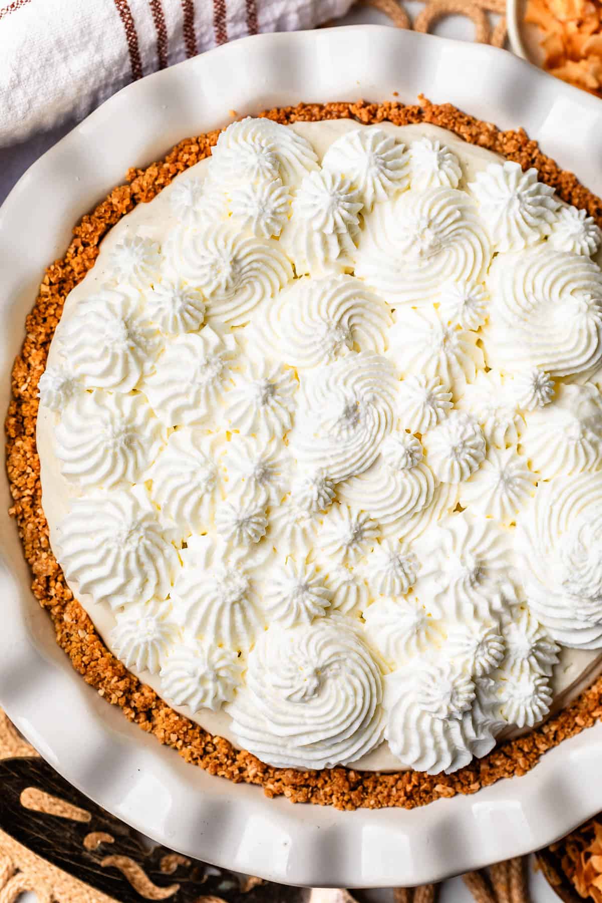 looking down on a pie topped with whipped cream piped in swirls.