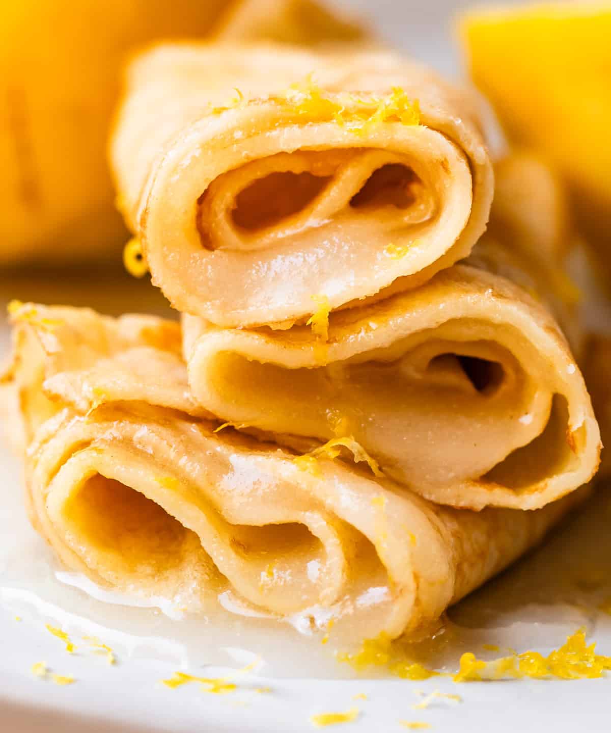 3 rolled up crepes with lemon juice and sugar rolled into each.