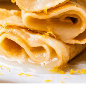pinterest image lemon rolled crepes with text "truly the best crepes I've ever had".