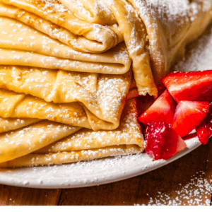 pinterest image of sugar topped crepes with text "truly the best homemade crepes".