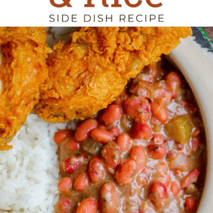 A plate of Cajun red beans and rice with crispy fried chicken, featuring fluffy white rice, creamy red beans with vegetables, and golden-brown chicken. Text reads: Cajun Red Beans & Rice Side Dish.