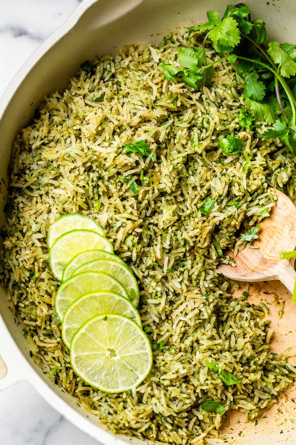 large pot filled with cilantro lime rice, garnished with lime and cilantro.