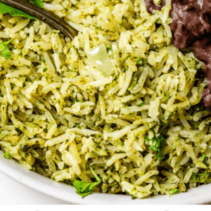 pinterest image of rice with beans and a fork with text "homemade cilantro lime rice".