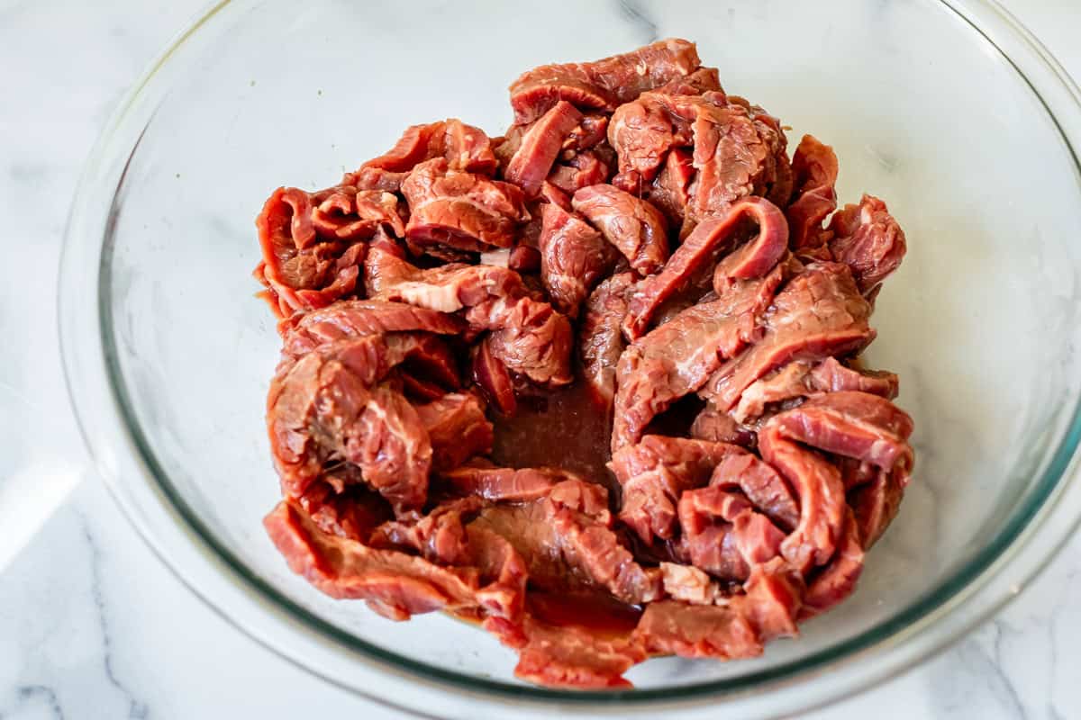 strips of beef marinating in shaoxing wine.