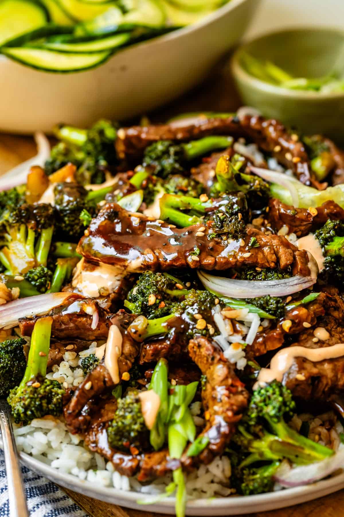 side angle shot of beef with broccoli on a plate with rice.