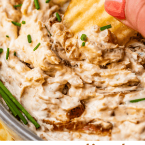 pinterest image: fingers holding chip scooping dip with text "caramelized French onion dip".