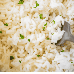 Pin image of how to cook rice on the stove.