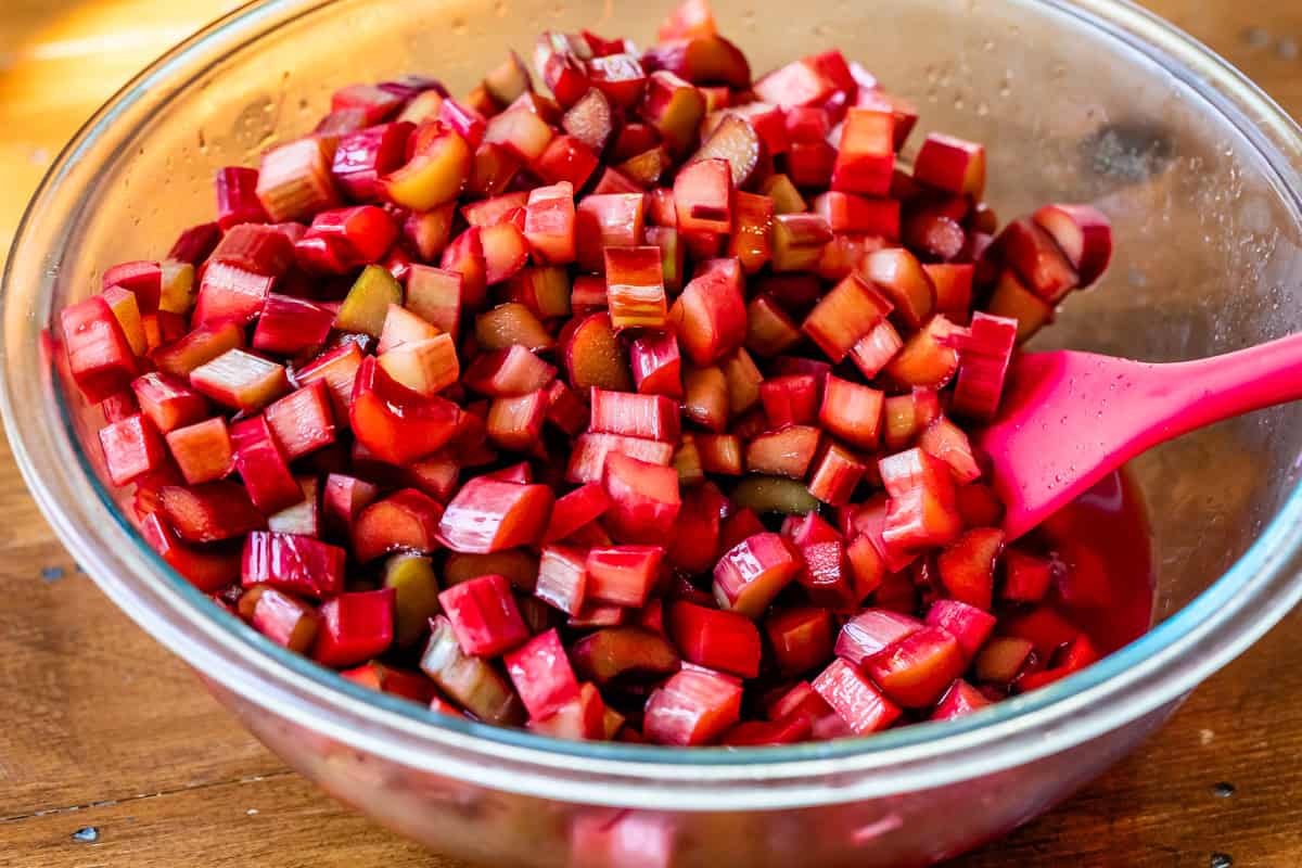 chopped rhubarb soaking in grenadine in a glass bowl to get extra red coloring.