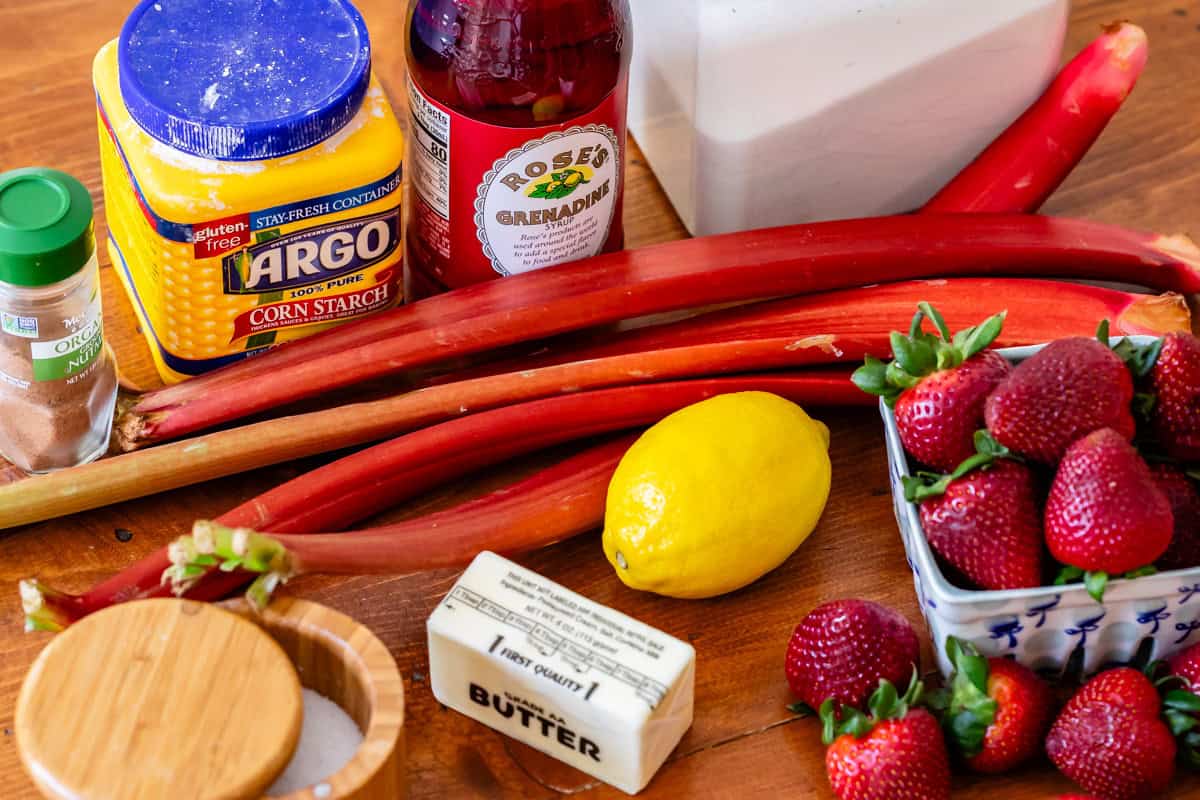 ingredients for strawberry rhubarb pie like rhubarb, strawberries, butter, lemon, etc.