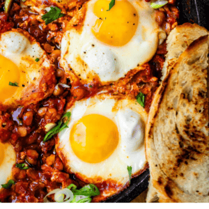 pinterest image of shakshuka with text that says "quick & easy shakshuka with white beans".