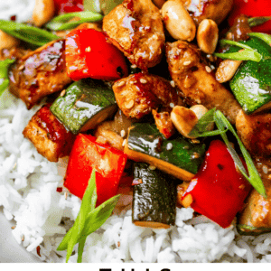 Pin image of kung pao chicken on rice with bright vibrant veggies and peanuts.