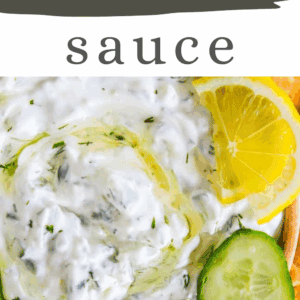 A bowl of creamy tzatziki sauce garnished with olive oil, lemon, and cucumber slices. Text reads tzatziki sauce, get the recipe, and www.thefoodcharlatan.com.